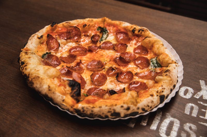 luce pizza with spicy pepperoni and chili flakes